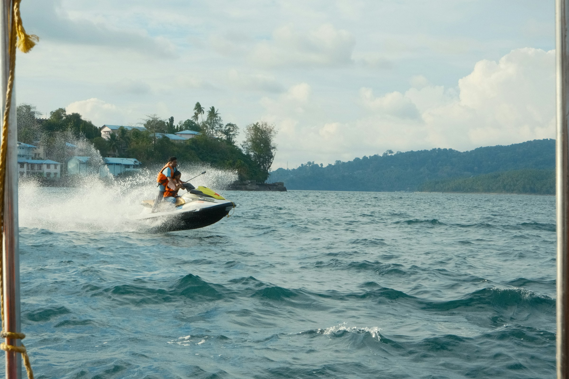 Person riding a jet ski on a wavy blue ocean